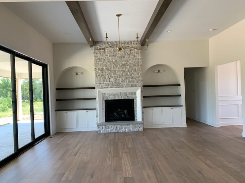 Interior painting around a stone fireplace and built-ins in a Wichita home